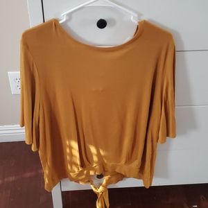 Mustard yellow shirt with an open back.